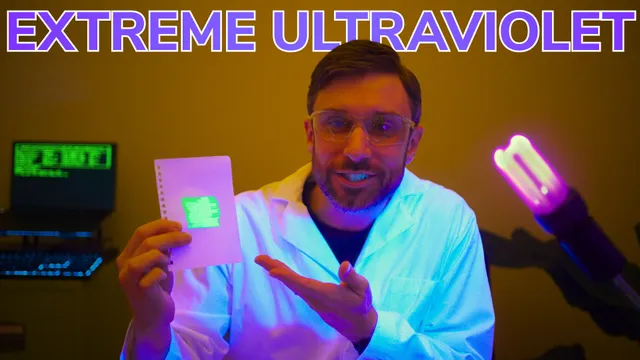 A picture of me in a lab coat, glowing blue under ultraviolet light, with EXTREME ULTRAVIOLET written across the top (a still from the video mentioned in the toot!)