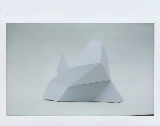 Polaroid photograph of a paper model of an iceberg