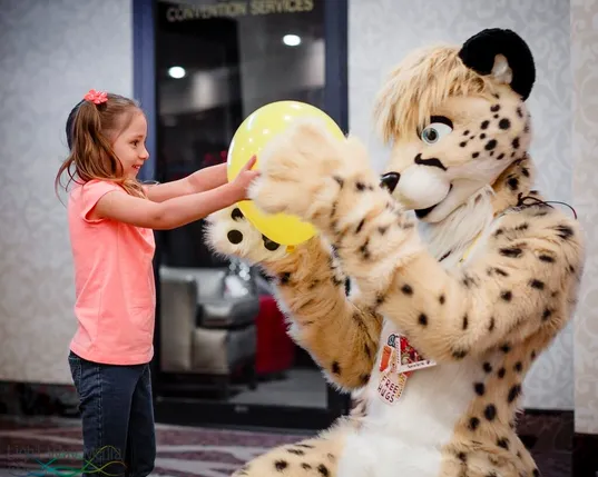 Shadow giving a girl a balloon.