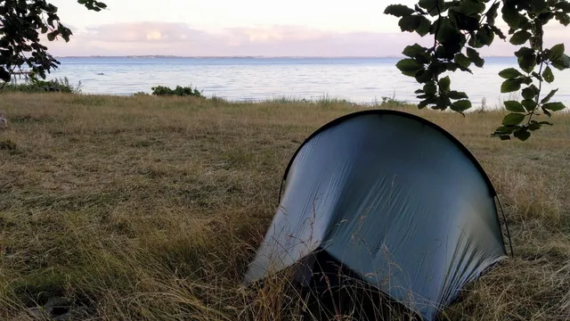 My tent pitched near the water in Denmark. The campsite is overlooking the sound of Kattegat and in the distance you can see the Swedish coast.