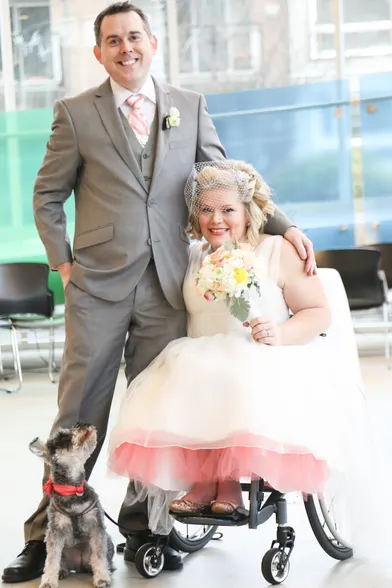 Tod and Jocelyn at their wedding, posing with their dog.