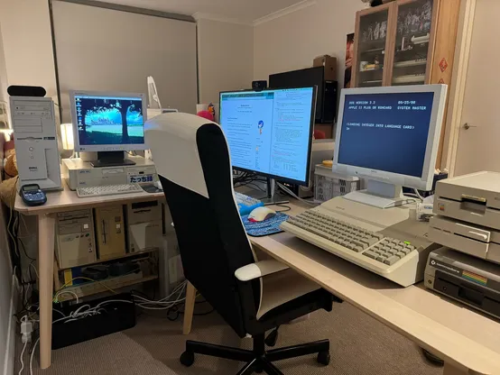 Desk showing (from left to right) the 32-bit PC stack (although technically the 386SX is kinda 16-bit), the current desktop, and the Apple //e and Commodore stuff. One day I’ll hopefully have space to not need all these KVMs, but for now it works :’)