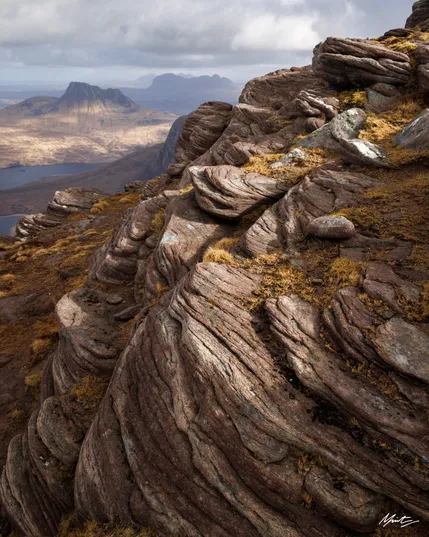 dappled light over the scottish moors with torridonian sandstone in the foreground