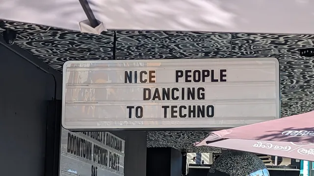 Picture of a marquee outside of a dance club that says "Nice people dancing to techno"