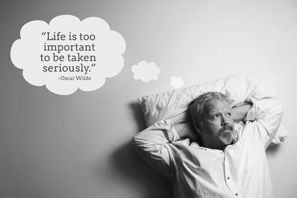 Black and white photo of Mark , with hands folded behind head on a pillow, thinking: "Life is too important to be taken seriously." –Oscar Wilde