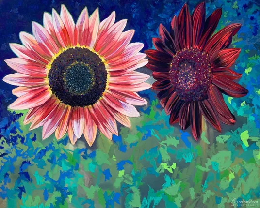 Pastel painting of two finely detailed sunflowers, the left one in shades of pink and facing forward, the right one in reds and turned towards the other. The background of blues and greens is still unfinished, as are the stems and leaves (to be added).