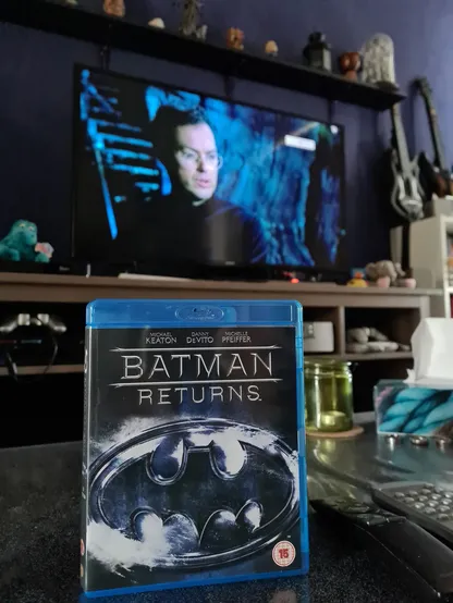 Box of Bluray edition of Batman Returns with Bruce Wayne on the TV in the background. 