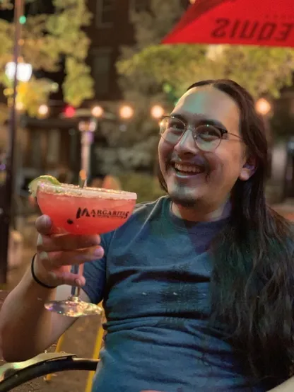 Me holding a red margarita.