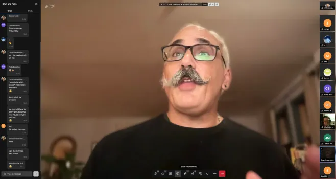 Screenshot of Jitsi meeting app with Evan in the center reading his book