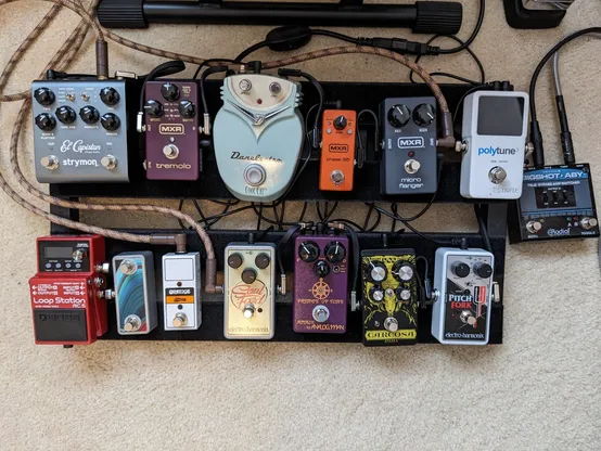 A collection of guitar pedals on a pedal board.
- Radial Bigshot ABY
- TC Polytune 3
- EHX Pitchfork
- DOD Carcosa
- Analog.man Prince of Tone
- EHX Soul Food
- MXR Micro Flanger
- MXR Phase 95
- Danelectro Cool Cat Chorus
- MXR Stereo Tremolo
- Strymon El Capistan
- Boss RC-5 with Saturnworks dual footswitch