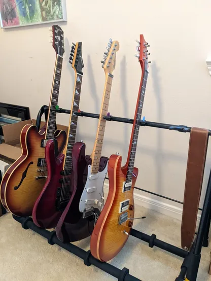 A collection of guitars on a stand:
- PRS SE Custom 24-08
- Fender Deluxe Strat Plus
- Samick KJ-560
- Epiphone Inspired by Gibson ES-335 Figured