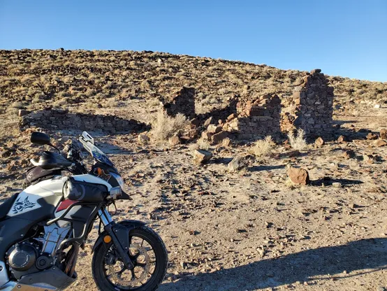 Rode my white Honda motorcycle out to the rock wall ruins of  Hawes Station, an Overland Stage / Pony Express /  Emigrant Trail stop, The ruins sit on the slope of a sage and rock covered hill and are adjacent to a small flat lake bed that is off camera.