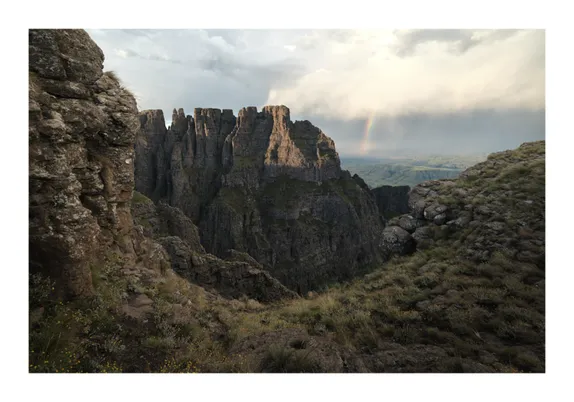 The Dragons Teeth (2024)
A grand landscape image showing the expanse of the Mnweni Spires, a storm and rainbow can be seen in the distance.