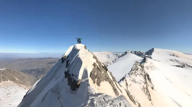 People on top of the peak Salon in Spain's Sierra Nevada in winter