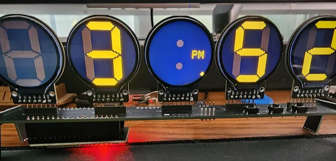 Photo of the same 5 displays  this time it shows a clock that says 3:52 PM