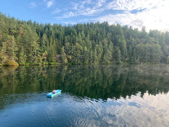 a sunlit scene of a rowboat on my favorite (secret!) lake.