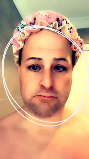 A silly video of me in my shower cap (pink with little unicorns on it) pointing at my head repeatedly. There are labels and glyphs on the screen that also are pointing to my head and indicating what it is.