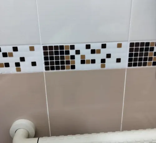 Bathroom title whose square pattern looks like a Github activity log that is slowly decreasing as time goes on.