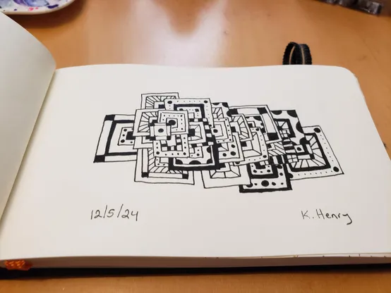 Hand drawn generative/procedural art in ink on an open page of my sketchbook. The abstract pattern looks a bit like a messy pile of geometric drawing.