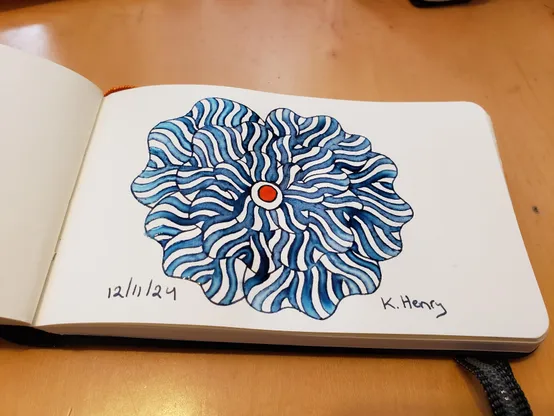 Hand drawn generative/procedural art in ink on an open page of my sketchbook. The abstract pattern is floral.
