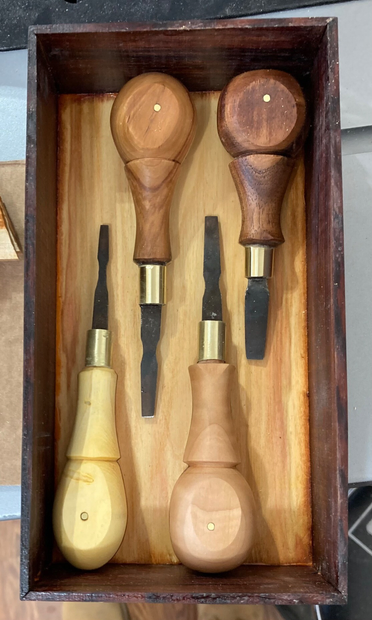 A set of screwdrivers in a wooden box.