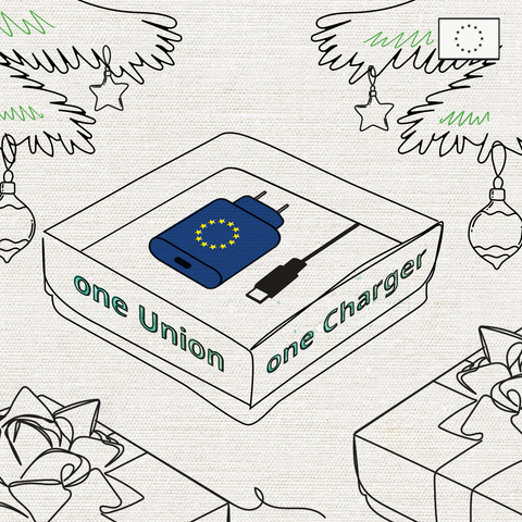 A minimalist illustration showing a packaged charger box labeled "one Union one Charger." The box features an image of a blue charger with the European Union flag symbol and a USB-C cable. The scene is set within a holiday theme, with decorative Christmas trees, ornaments, and gift boxes surrounding the charger box. In the top right corner, there is a small EU flag symbol.