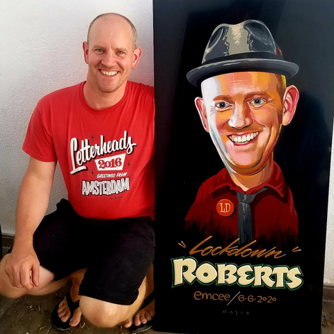 Man crouching down next to a stylised portrait of himself captioned 'Lockdown Roberts'.