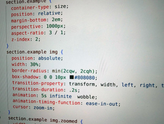 Photo of a monitor showing some CSS code. The code hints at a website where images are animated and zoomed.