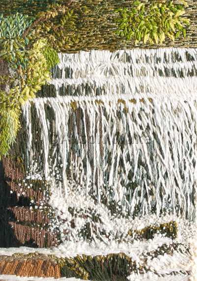 Stitched artwork depicting a waterfall. Water is falling onto stepped rocks resulting in bubbles and splashes 