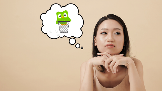 Woman thinking about throwing Duolingo in the trash