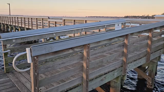 41 seconds of video from the "County Dock" off Mandarin Road, Jacksonville, Florida. The video moves across the scenery from left to right, starting with a view down the pier at the shoreline, then across the river where a colorful sunset is in progress, and continues across the river to the other end of the pier.