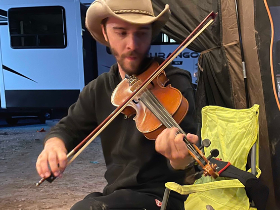 Me playing the fiddle in a gazebo where we boondocked in the desert with friends.