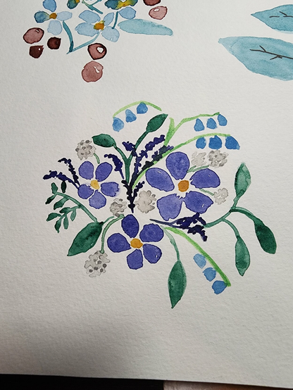 A small watercolor sketch of purple flowers with yellow centers and brighter blue bell-shaped flowers, with some white puff balls and green foliage, berries and buds. 