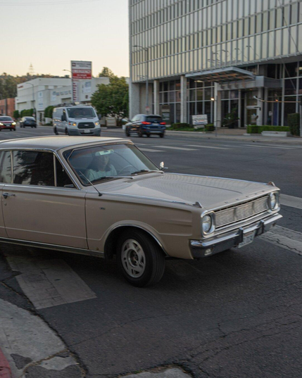 A classic old Dodge care takes a right on a Los Angeles city street