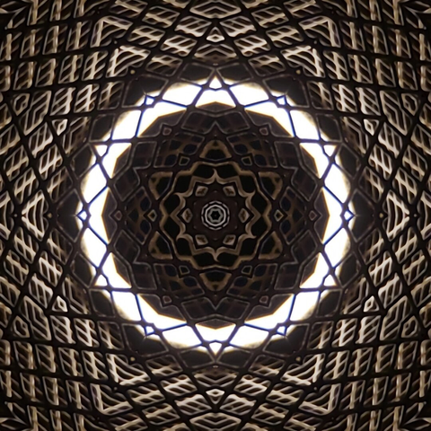 A digital art piece consisting of concentric 6-pointed star shapes in brown tones, divided by a white ring toward the center.