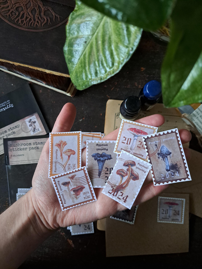 Six stamp shaped stickers with painted mushrooms on them