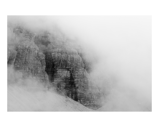 Dolomiti rock face detail in black and white under heavy fog