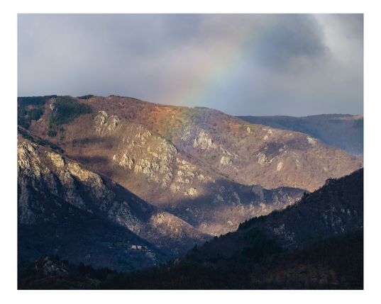 Rainbow after the storm on mountain background 