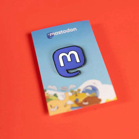 Photo of the Mastodon metal pin, with the Mastodon logo.
