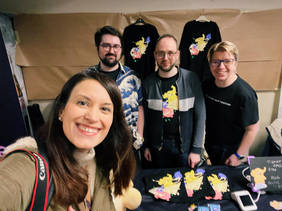A photo of a smiling woman with long brown hair and behind her Eugen, Renaud and Andy from Mastodon 