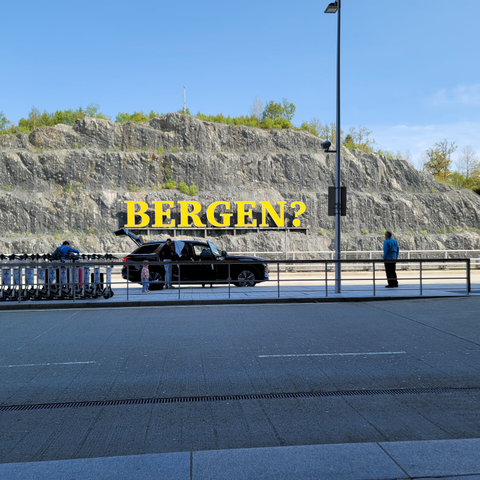 A photo taken from the Bergen Airport that has an art installation labeled "BERGEN?"