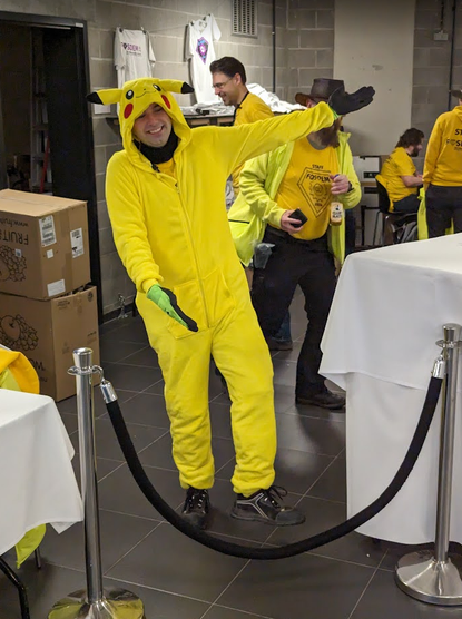 FOSDEM staff in a Pikachu suit