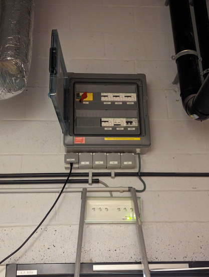 A small power distribution box, one breaker tripped.