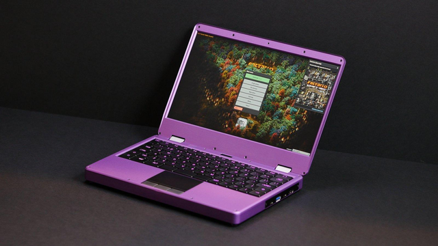 A super cute purple laptop with the game Factorio on the screen. 