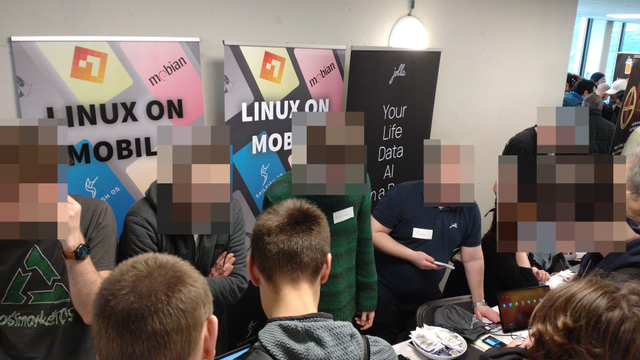 A closer photo of the stand with the attendees talking across the table to all the many people running the stands.