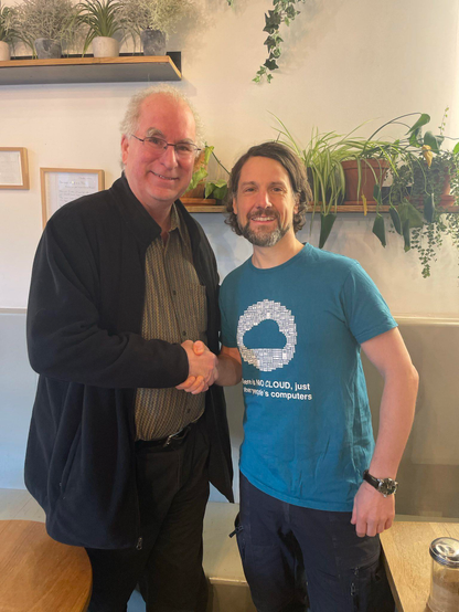 Two people thanking each other by shaking hands.