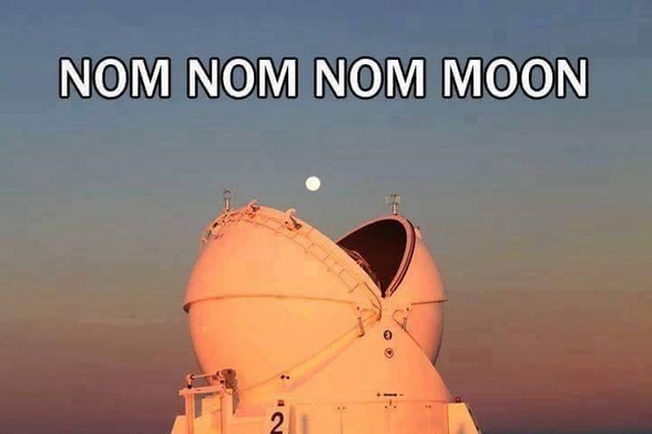 Photo shows a large ground-based telescope under an evening sky with a view of of The Moon directly above its open covers. It looks like something opening its mouth to eat The Moon directly out of the sky. Overlaid text reads: NOM NOM NOM MOON