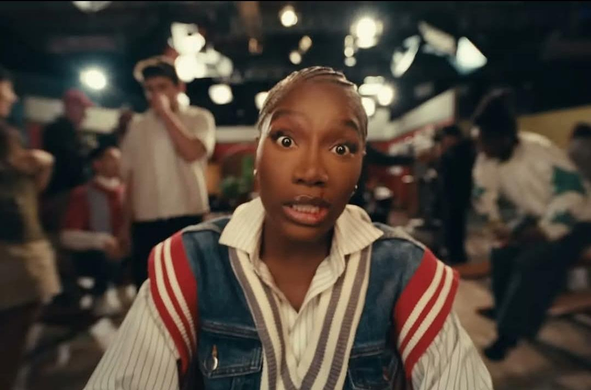 Doechii, in the film clip of her song "Denial is a River" (which the post is mirroring)