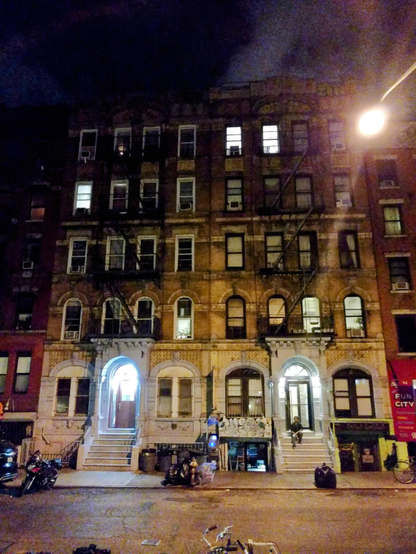 I was taking a walk with my nephew in East Village, we were looking for a place to have a drink. We turned a corner and, despite me being there for the first time, it felt strangely familiar. I said "wait... this place... it's got to be one of those!"

I checked on my phone and indeed, that was St. Mark's Place, the street were the iconic building on the cover of Led Zeppelin's "Physical Graffiti" album still stands. We searched around a bit, and sure enough, there it was. It is a bit taller in real life: the album art cut it down one story shorter to make it fit square cover.

I sat on the stairs and asked my nephew to take a picture from the other side of the street. One can barely make out that it's me, but every time I look at this picture I remember that night, and I feel like I'm in that album cover. Every time I look at the album cover, I feel like I'm on that street.