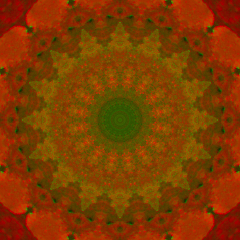 Colorful mandala with fiery red tones and some green in it.